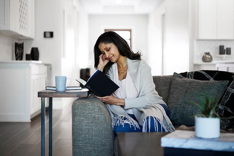 a woman sitting at a table using a laptop